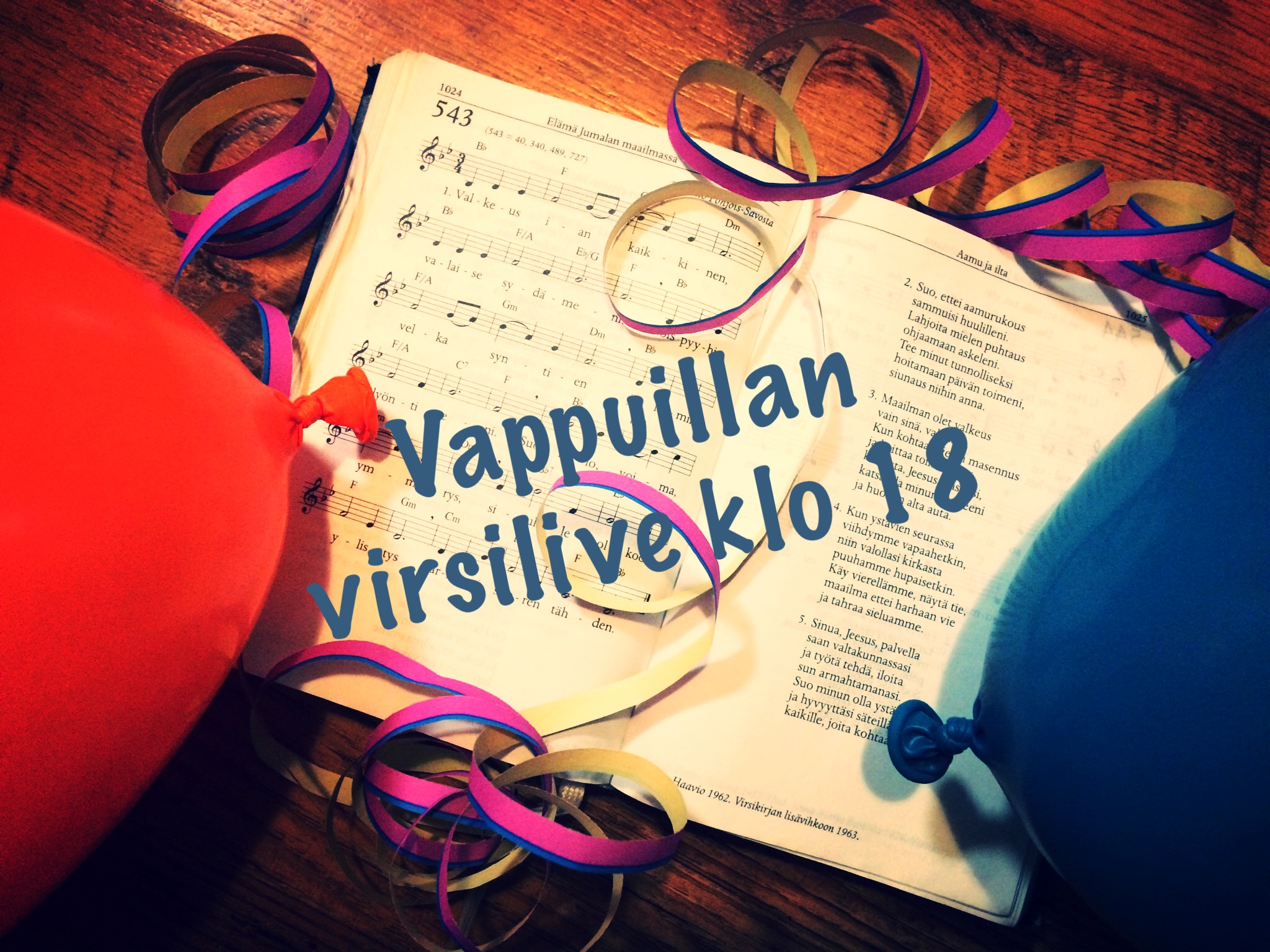Vappuillan virsilive Kuvassa avoin virsikirja, ilmapalloja ja serpentiiniä.
