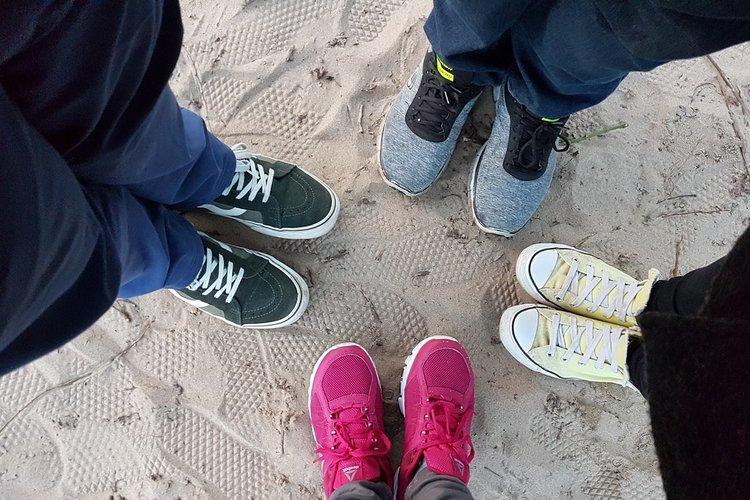 Neljät kengät hiekalla